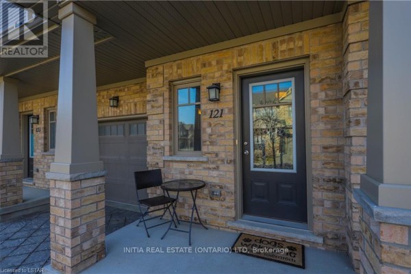 Townhouse unit 121 entrance with single chair and small table. - 121 - 1924 Cedarhollow Boulevard, London North