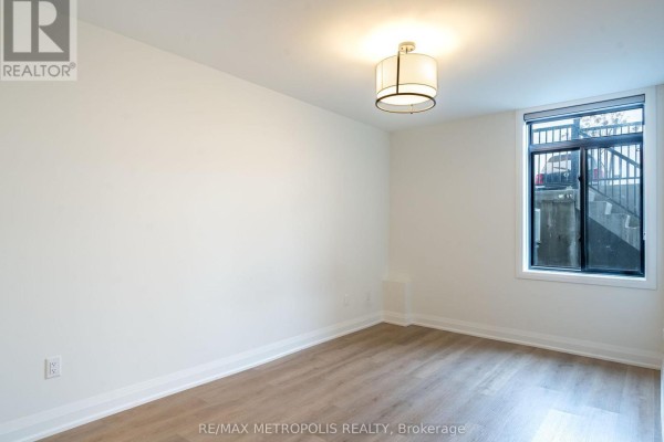 Empty room with light wood floors, white walls, and a window with a view. - 121 - 3900 Savoy Street, London South