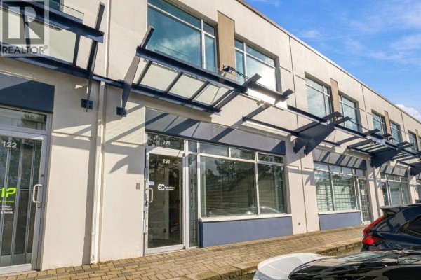 Close-up of a commercial unit entrance with glass doors, awnings, and building number 121. - 121 3989 Henning Drive, Burnaby