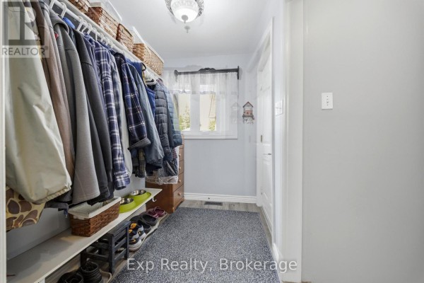 Hallway with open closet, shoe rack, and window - 121 Simcoe Street Greater Napanee