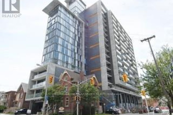 Street view of a modern apartment building on Lyon Street, Ottawa, with traffic lights and cars. - 1210 - 224 Lyon Street, Ottawa