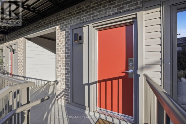 Close-up of a red townhouse door with unit number 1210 and adjacent windows. - 1210 - 2635 William Jackson Drive, Pickering