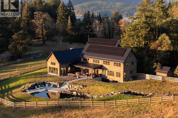 Aerial perspective of the house featuring a pond and landscaped yard. - 1210 Cherry Point Rd, Cobble Hill