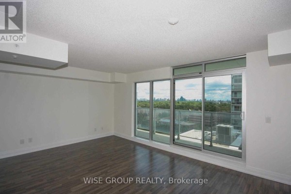 Bright living space with hardwood floors and large sliding glass doors leading to a balcony. - 1210w - 565 Wilson Avenue, Toronto