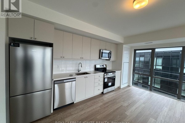 Modern kitchen with stainless steel appliances, white cabinets and a large window. - 1212 - 51 Clarington Boulevard, Clarington