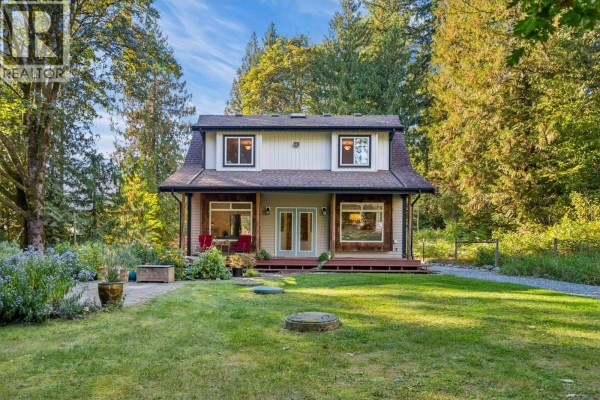 Front view of a beige and grey two-story house with a covered porch and double doors. - 12121 264 Street, Maple Ridge