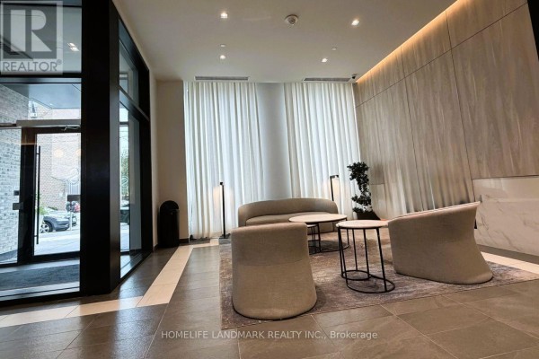 Building lobby with contemporary seating, modern lighting, and floor-to-ceiling sheer curtains. - 1217 - 1 Jarvis Street, Hamilton