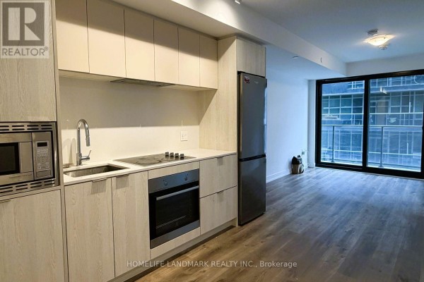 Apartment kitchen with light wood cabinets, stainless steel appliances, and a sink. - 1217 - 1 Jarvis Street, Hamilton
