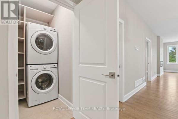Stacked LG washer and dryer with shelving - 1217 Potter Drive Brockville