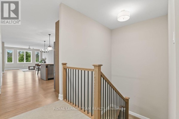 Open concept living and kitchen area with island and staircase - 1217 Potter Drive Brockville
