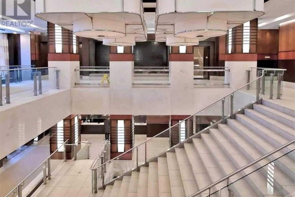 Wide view of the multi-level lobby with staircases and seating areas. - 1219 - 33 Cox Boulevard, Markham