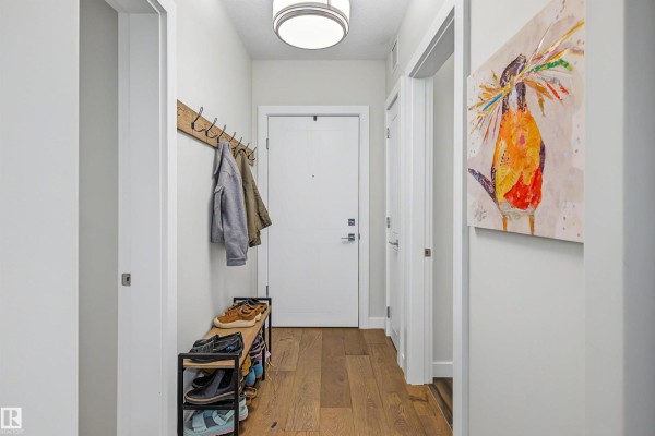 Entryway hall with a shoe rack, coat hooks, and a front door. - #122 61 Festival Wy, Sherwood Park