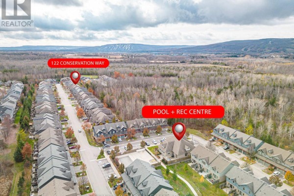 Aerial view showing 122 Conservation Way, a pool and rec center, and ski hills. - 122 Conservation Way, Collingwood