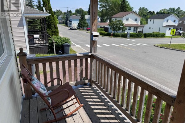 View from the porch with a rocking chair, looking out at a street and houses. - 122 Lincoln Road, Grand Falls Windsor