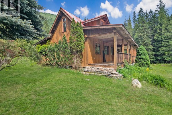 Carpeted attic room with sloped ceiling, built-in shelving, and a window with a forest view. - 122 Perepolkin Road, Hills