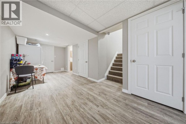 Dining room with large window, wooden table, and gray chairs. - 1220 Riverbend Road Unit# 105, London