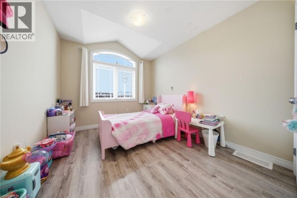 Aerial view of neighbourhood with townhouses, park, and street. - 1220 Riverbend Road Unit# 105, London