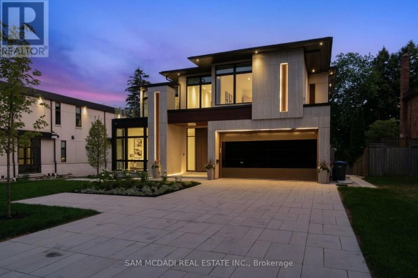 Contemporary Mississauga residence facade with dark wood, stone, and glass details. - 1222 Mississauga Road, Mississauga