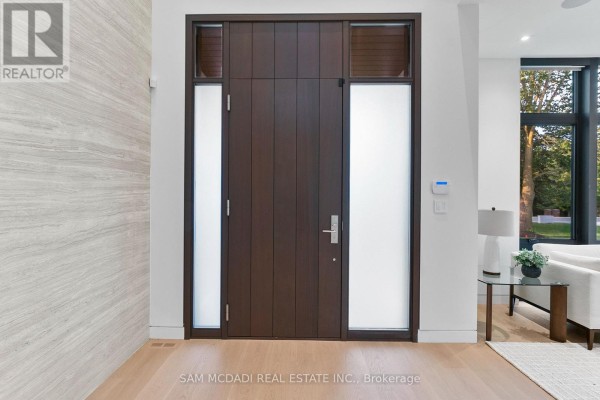 Dark wood double front door with frosted glass sidelights and light wood floor. - 1222 Mississauga Road, Mississauga