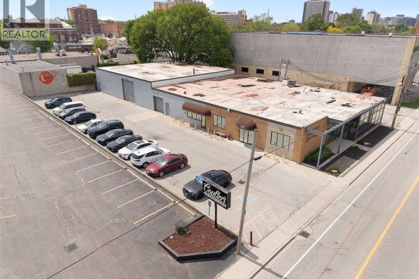 Floor plan of a commercial building showing multiple rooms and a large open space. - 1225 Mcdougall, Windsor