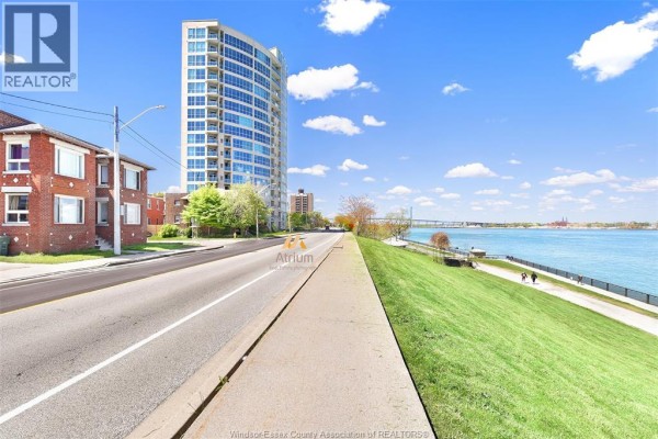 Riverfront park with apartment building and bridge - 1225 Riverside Unit# 409 Windsor