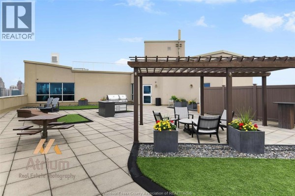 Rooftop patio with pergola, grill, picnic table, and seating - 1225 Riverside Unit# 409 Windsor