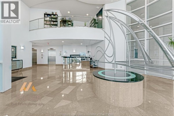 Modern lobby with sculpture, elevators, and marble floors - 1225 Riverside Unit# 409 Windsor