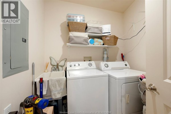 Laundry room with washer, dryer, utility sink, and storage - 1225 Riverside Unit# 409 Windsor