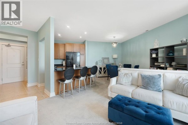 Entryway with white door, beige tile floor, and blue walls - 1225 Riverside Unit# 409, Windsor