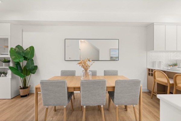 Wood dining table with six grey chairs in a room with light wood floors and white walls. - 123 2350 165 Street, Surrey