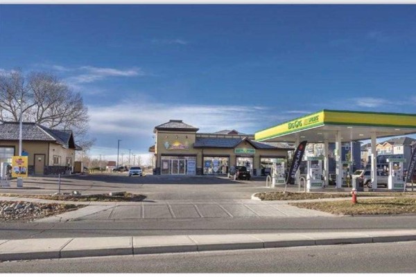 Wide exterior view of the commercial buildings, including a gas station, Taco Time, and convenience store. - 123 Any St  N, High River