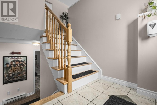 Interior staircase with light oak railings, white risers, and dark treads. - 123 Lancaster Drive, Dartmouth