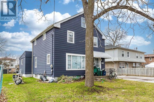 Rear side view of the blue house with a small attached structure on the left. - 1230 Duke Street, Cambridge