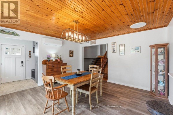 Wooden dining table & chairs, wood ceiling, modern chandelier, display cabinet - 1233 Lazier Road Tyendinaga
