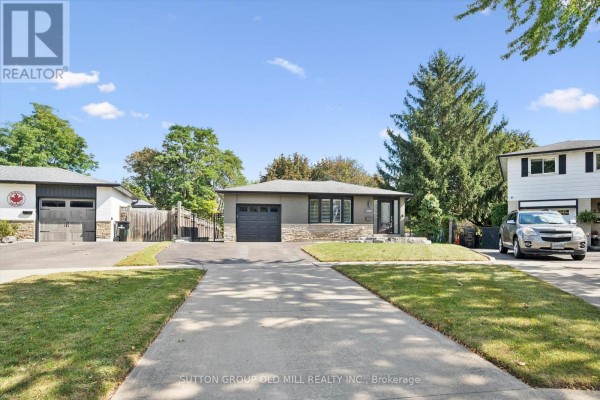 Street view of a single-family home with a grey and stone facade, driveway, and neighboring houses. - 1233 Michael Crescent, Cambridge