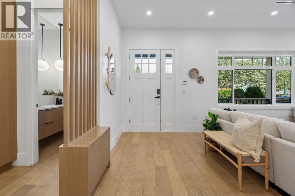 Open concept living, dining, and kitchen area with a fireplace, island, and modern furniture. - 1234 E 19th Avenue, Vancouver