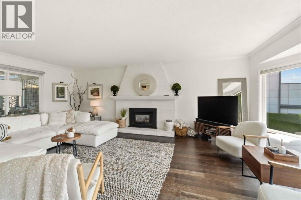 Interior entryway with white paneling, a white bench, dark hardwood floors, and glass double doors. - 1237 Ioco Road, Port Moody