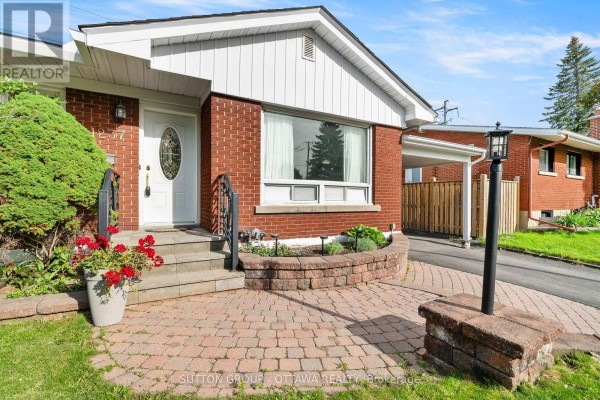 Front exterior of a brick bungalow with a paved driveway and a covered carport. - 1237 Whitmore Avenue, Ottawa