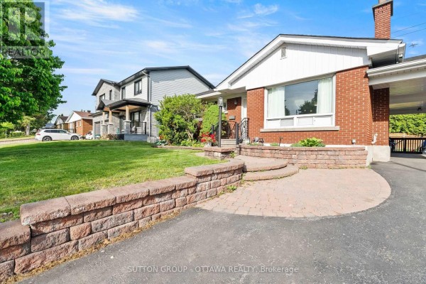 Side exterior of a brick house with a green lawn and mature trees. - 1237 Whitmore Avenue, Ottawa
