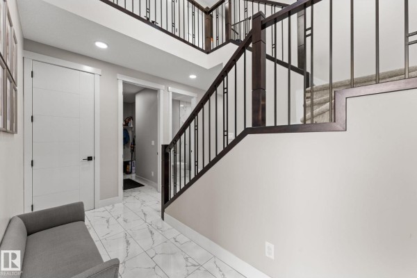 A bright home office with a window, white desks, and white chairs. - 12383 176 Av Nw, Edmonton