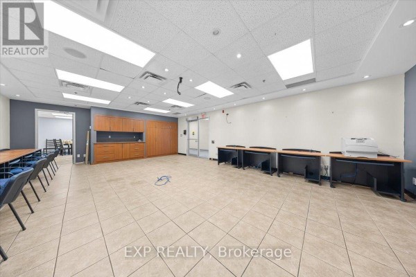 Wide view of building interior hallway with tiled floor and display cases. - 124 - 40 Sunset Boulevard, Perth