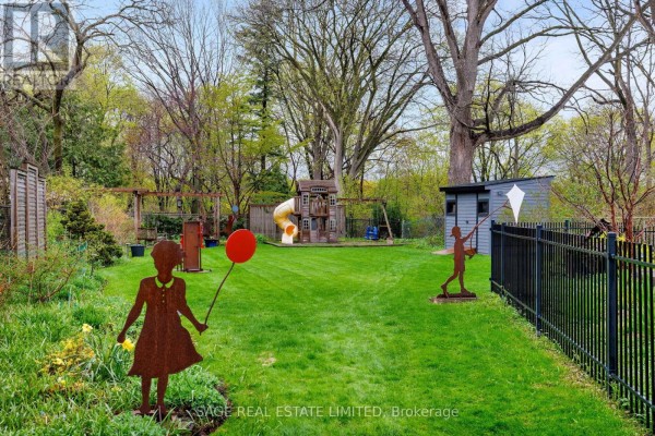 Backyard with play structure, slide, shed, and yard art - 124 Blythwood Road Toronto