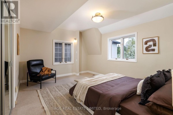 Bedroom with bed, armchair, and two windows - 124 Blythwood Road Toronto