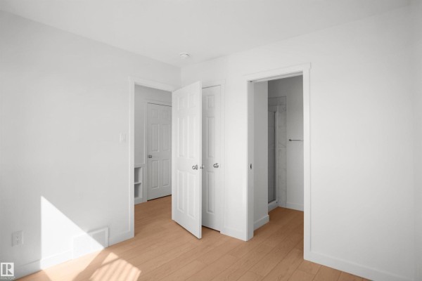 Bathroom featuring a white vanity, mirror, and toilet with modern lighting - 124 Copperhaven Dr, Spruce Grove