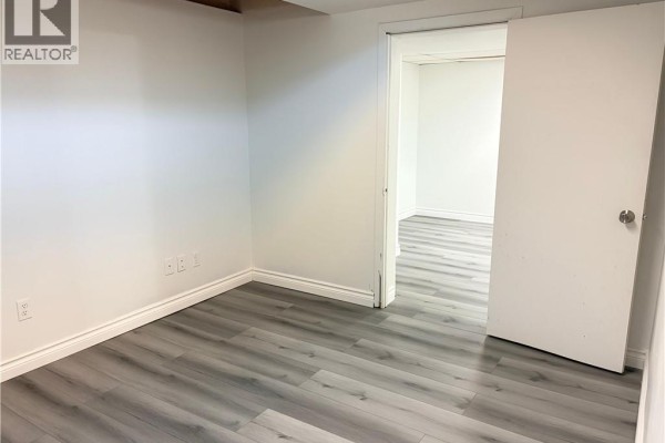 Second bedroom view with laminate flooring and doorway to living area - 124 King Street N Unit# 4, Waterloo