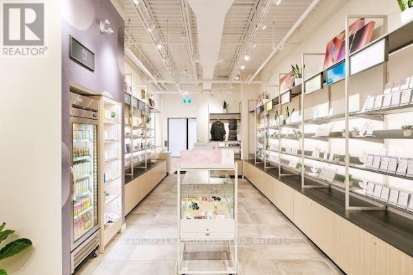 Interior view of retail space with display shelves, products, and modern lighting. - 1240 Commissioners Road W, London South
