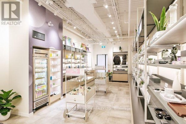 Another angle of the retail space showing product displays and organized shelving. - 1240 Commissioners Road W, London South