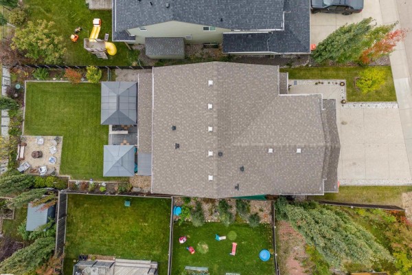 Aerial view of a residential property showing the house, backyard with patio, and surrounding fences. - 1240 Westerra Cr, Stony Plain