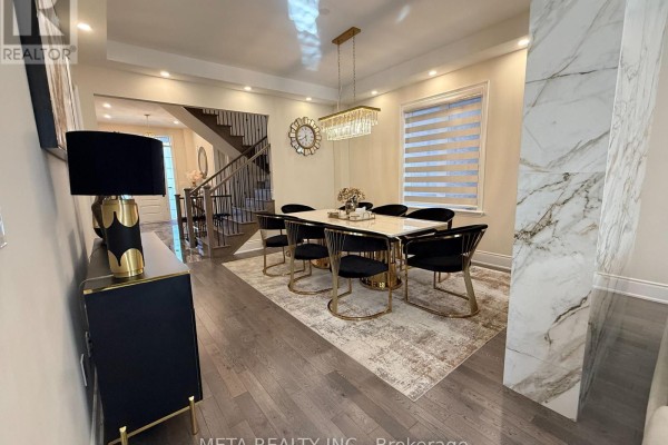 Dining room with black buffet, large mirror, and view of staircase and living area. - 1246 Pondside Trail, Oakville