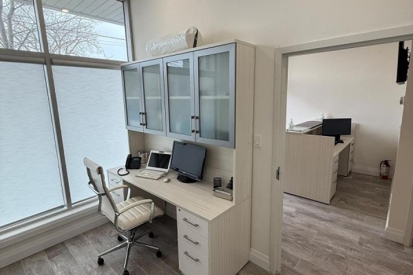 Office desk with computers and cabinets by a large window, adjacent to reception - 125 - 701 Sheppard Avenue W, Toronto